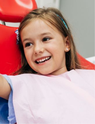Young girl smiling while giving a high five to her dentist